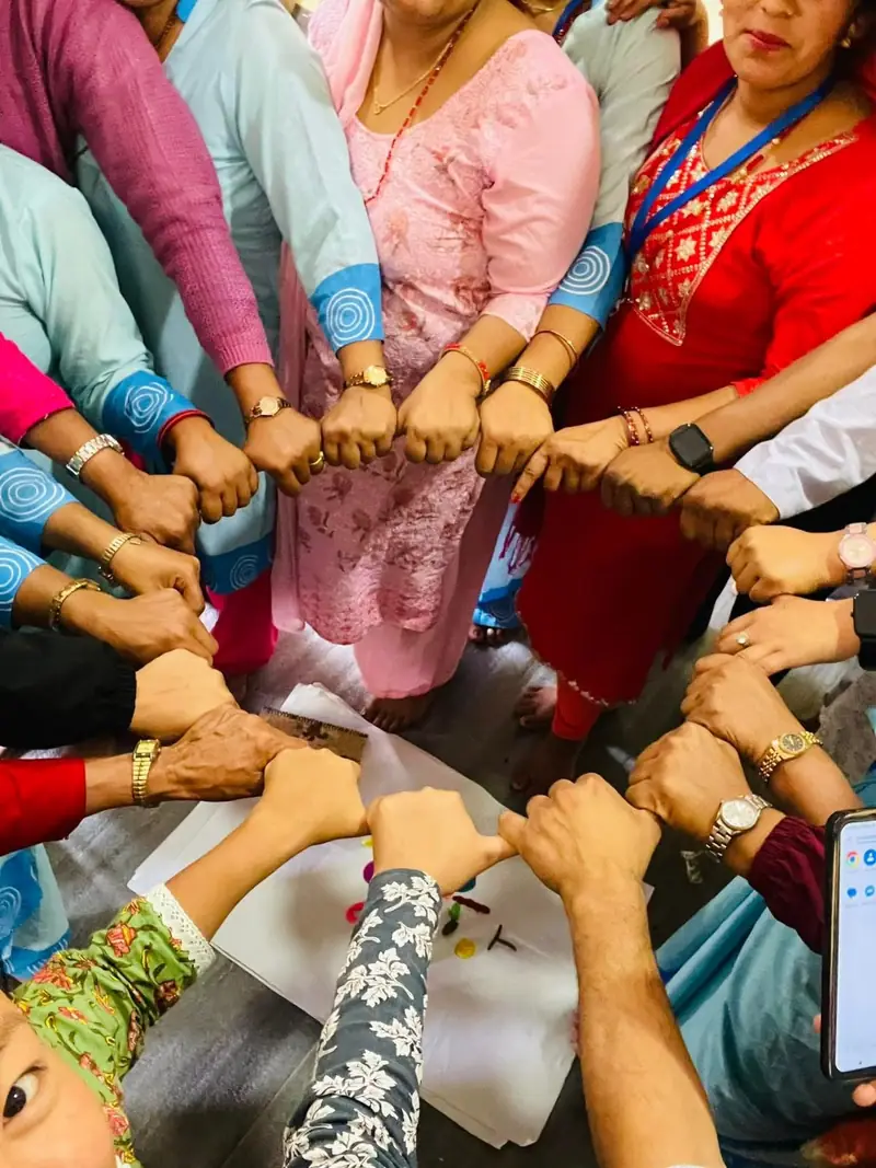 Participants joining hands in a circle